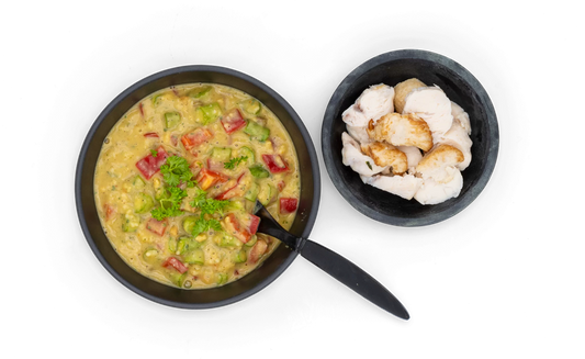 Bowl of couscous with a side of chicken