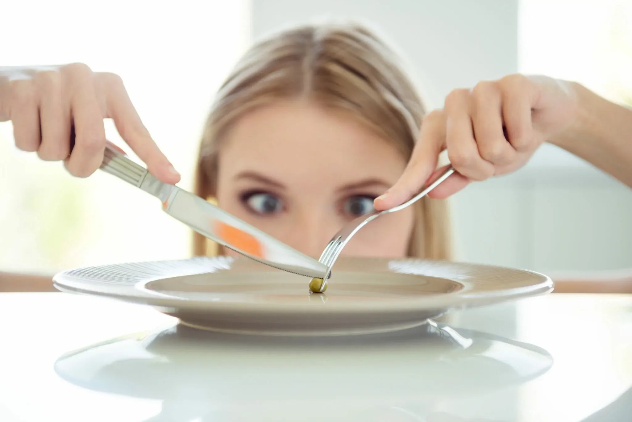 eating one olive with fork and knife